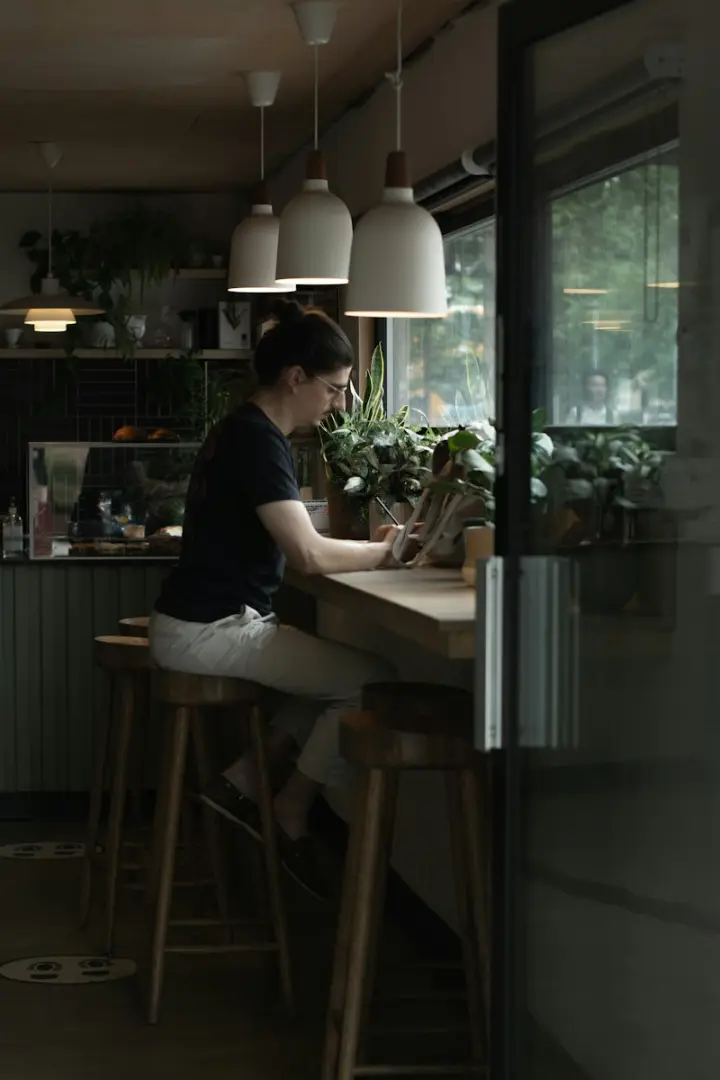Café owner working on a laptop at the counter